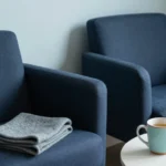 Waiting nook with two chairs, a wool throw and a mug of herbal tea